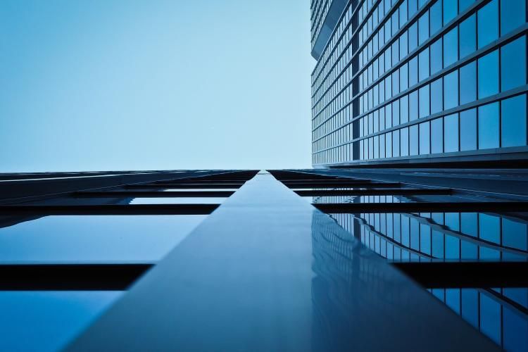 Image looking straight up the side of a tall office building