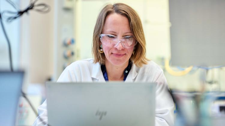 A woman sitting in front of a laptop