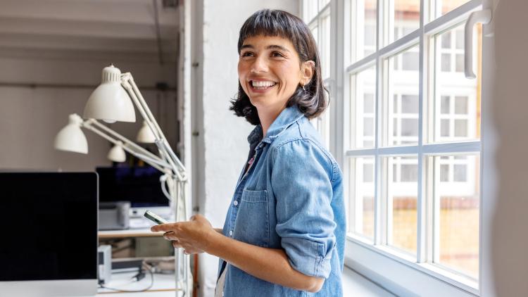 A woman smiling confidently looking at the camera