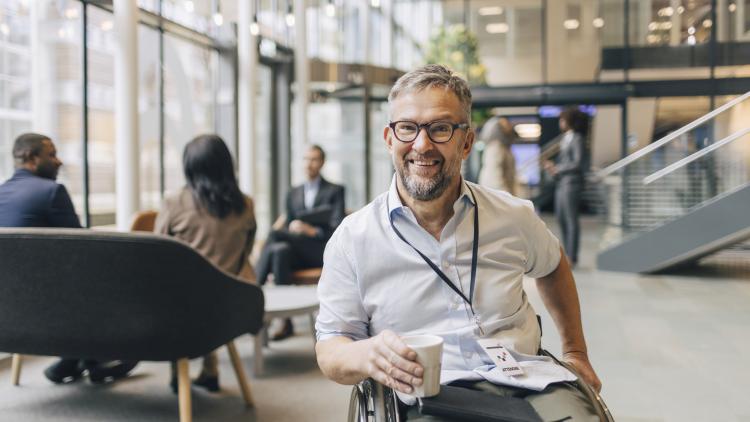 Smiling man in a wheelchair facing the camera