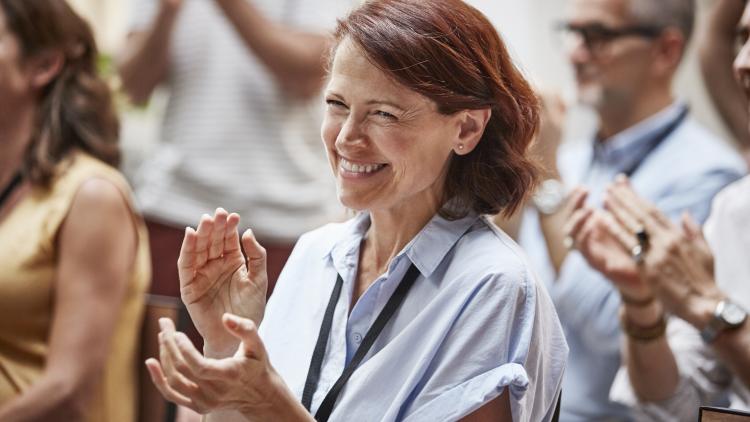 Woman smiling and clapping