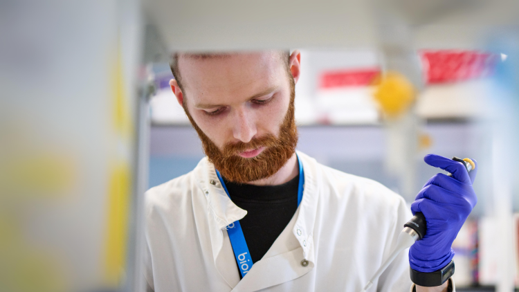 Scientist with a beard using a pipette