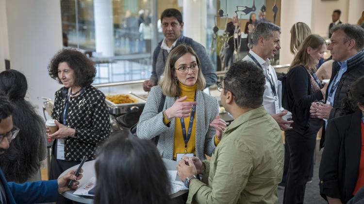 A group of people in discussion, mingling at a networking event