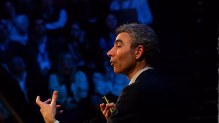 Nitzan Rosenfeld gestures during his keynote at the Innovation Summit 2025. 