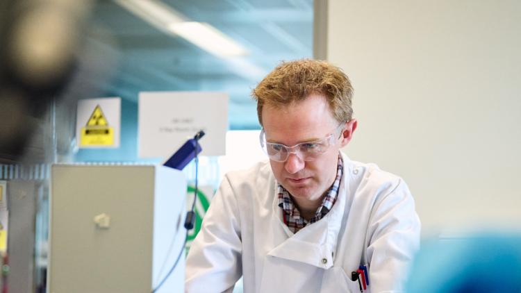 Scientist in white lab coat in a lab