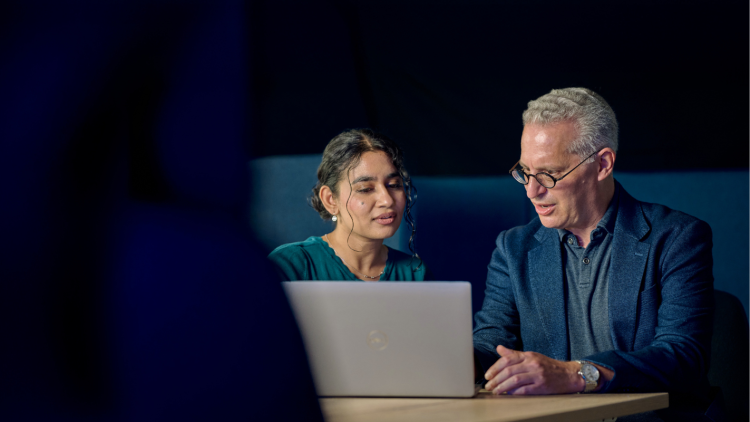 Man and woman looking at PC screen