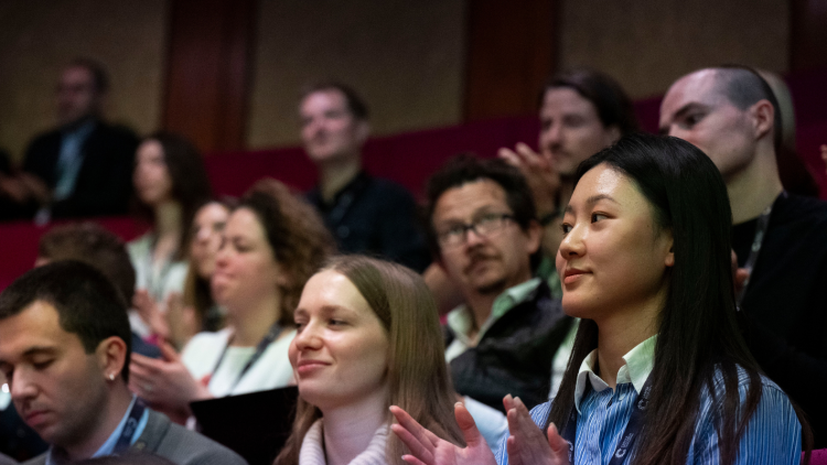 Image of crowd at a conference in a lecture theatre