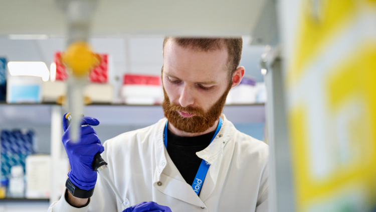 Scientist in lab holding pipette