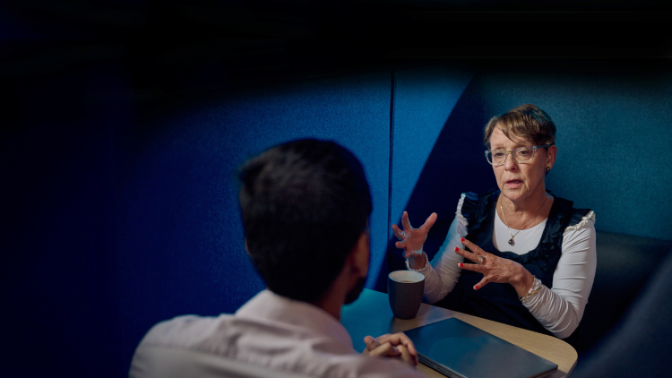 Woman speaking to a man across a table