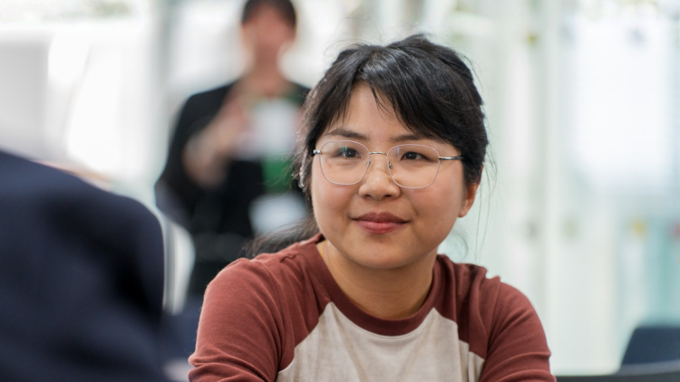 A young scientist wearing glasses and a red and white top