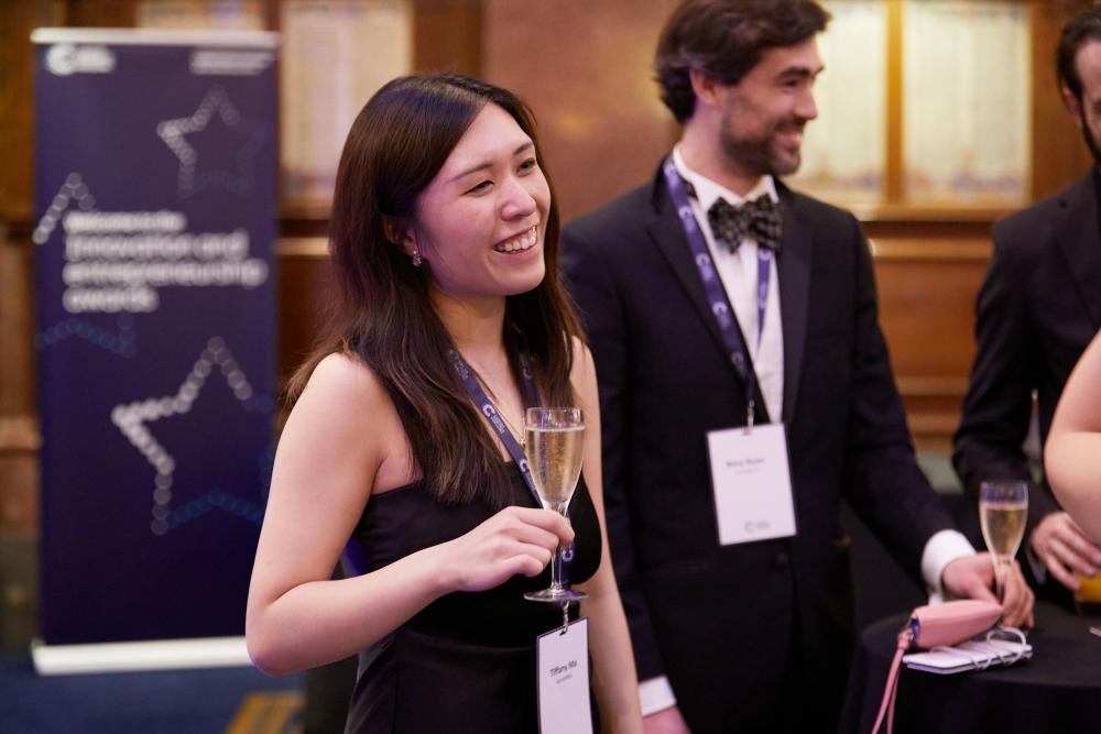 A woman smiling at an awards ceremony