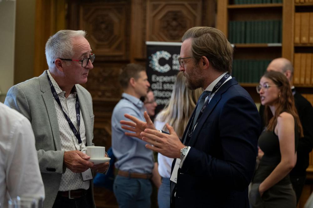 Two men speak at a conference